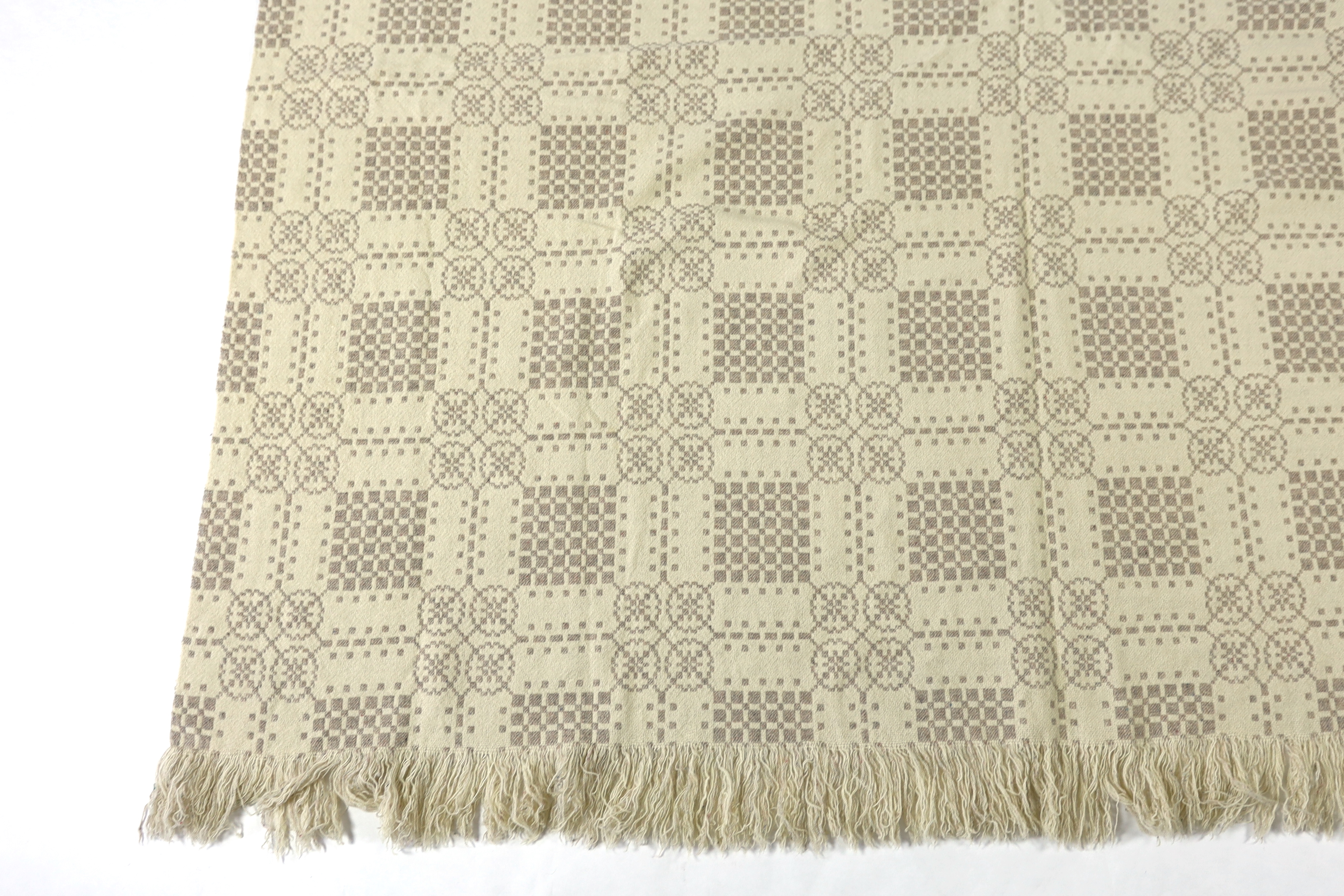 A Welsh wool woven blanket, using mushroom and cream wool in a reversible geometric design, 192cm wide x 212cm long